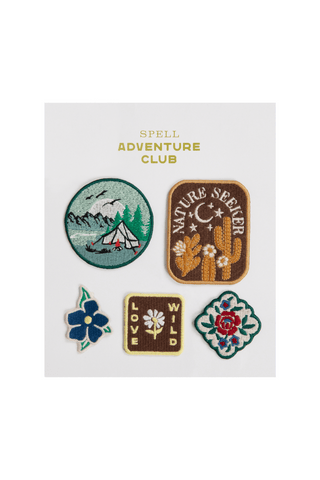 set-of-five-embroidered-patches-with-nature-themed-designs-on-a-white-card-featuring-the-brand-spell-adventure-club