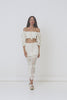 A studio video of model, Eden Bristowe, wearing of the Spell Let The Sunshine In Crochet Top. The top comes in a cream colourway and features voluminous sleeves ,that can be worn on or off the shoulder, and a functional drawstring neckline with tassels.